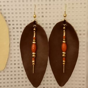 Dark brown teardrop earrings with coral stones.